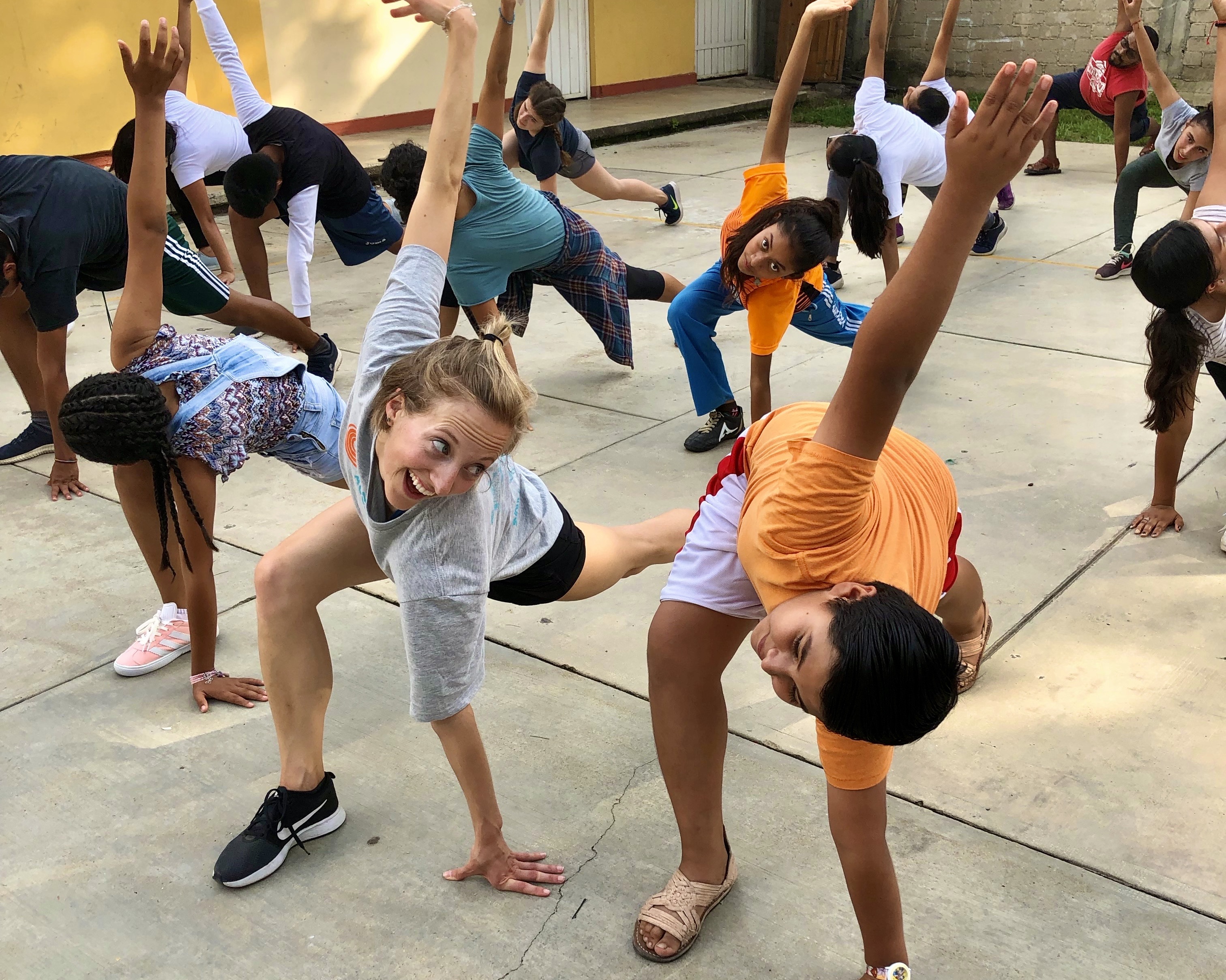 JUNTOSYouth dancers stretching with workshop participants (2019)